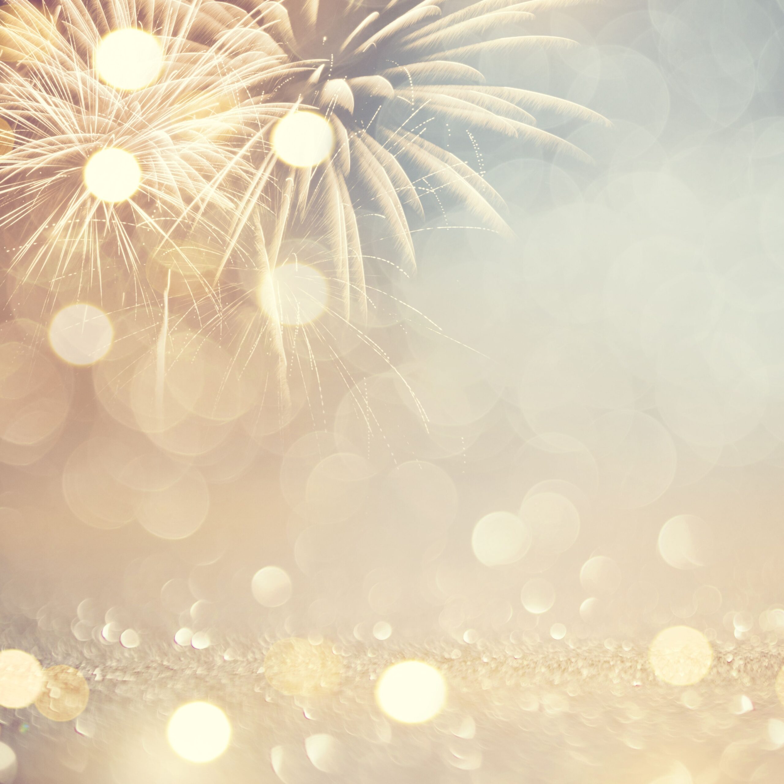 Soft golden fireworks and bokeh lights, symbolizing celebration, joy, and connection through special moments.